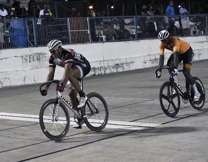 STILL TOPS: Former national rider and Trinidad and Tobago Cycling Federation president Michael Phillips, left, crosses the line to win another race in the Elite 2 Men’s category on the final night of the Trinidad and Tobago Cycling Federation’s Easter Grand Prix, at the Arima Velodrome on Sunday. —Photo: JERMAINE CRUICKSHANK